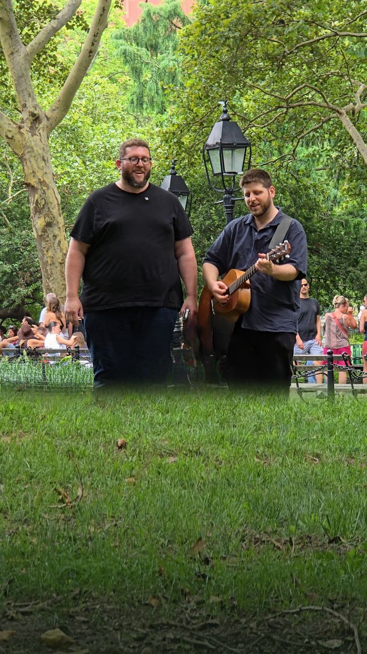 Adam and Eyal with a guitar in Washington Square Park